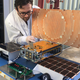A JPL engineer with one of the MarCO cube satellites.